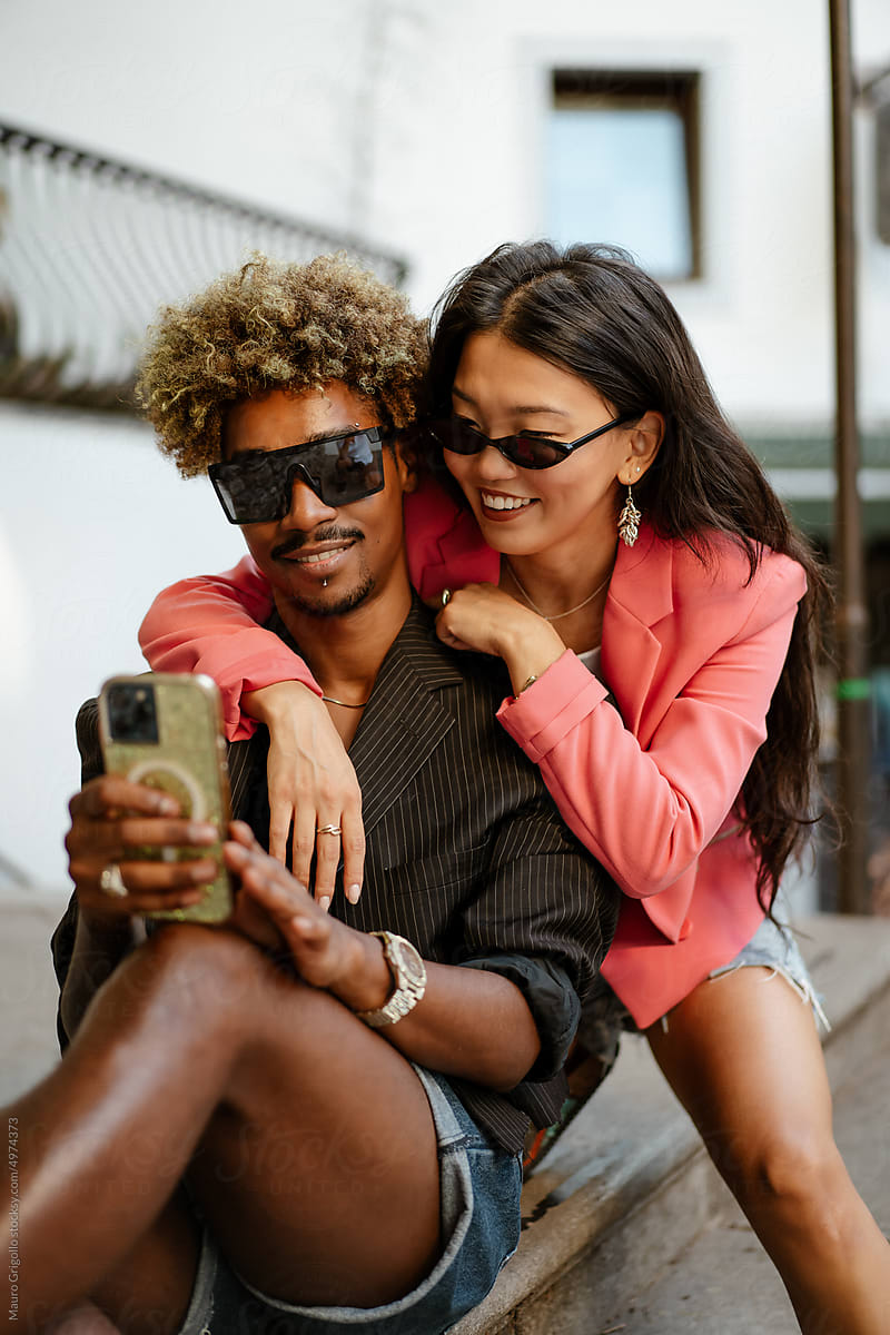 A couple takes a selfie with a mobile phone