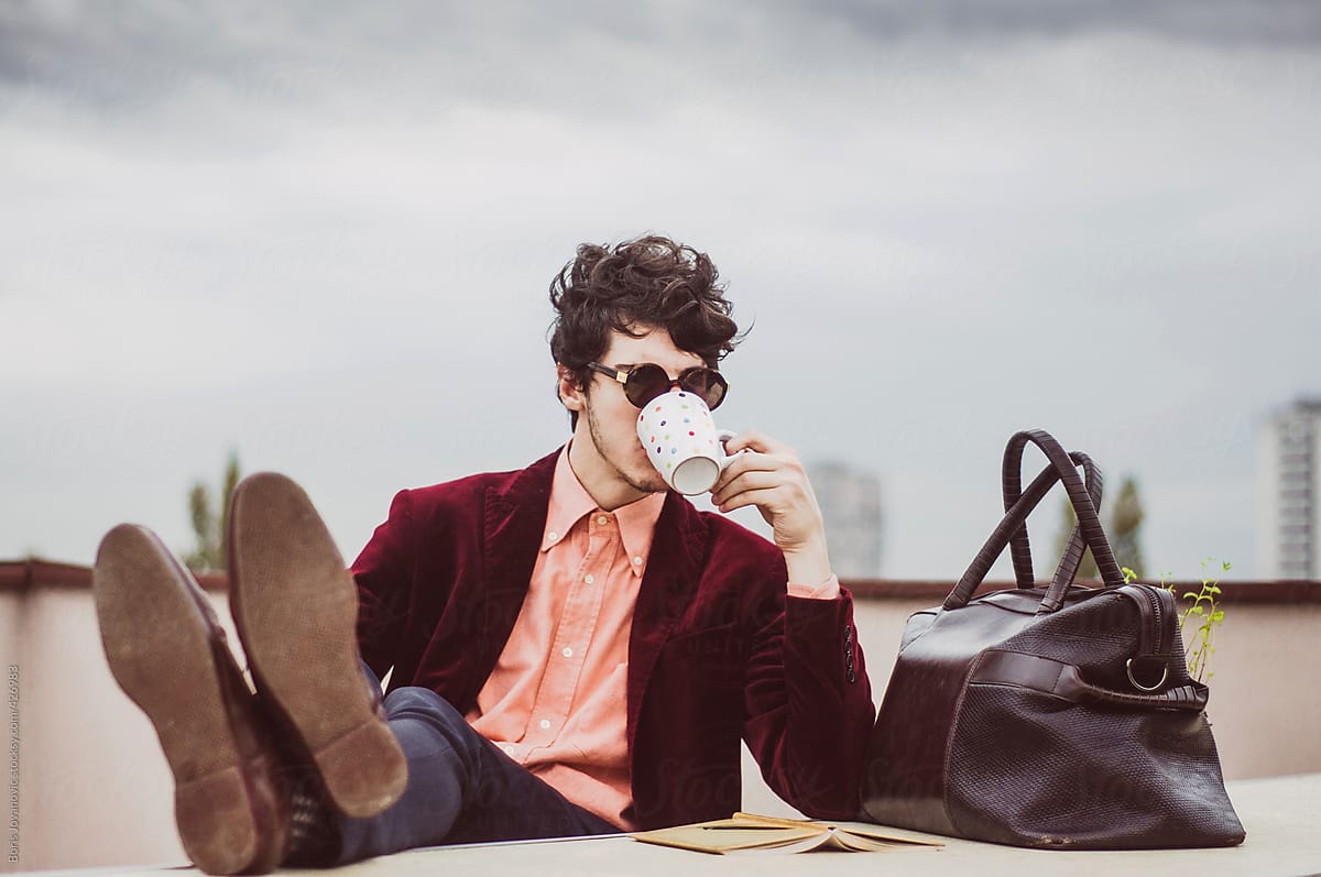 Man drinking coffee on a terrace