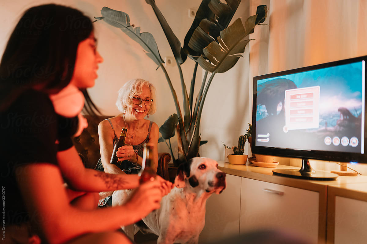 Women and dog playing videogames