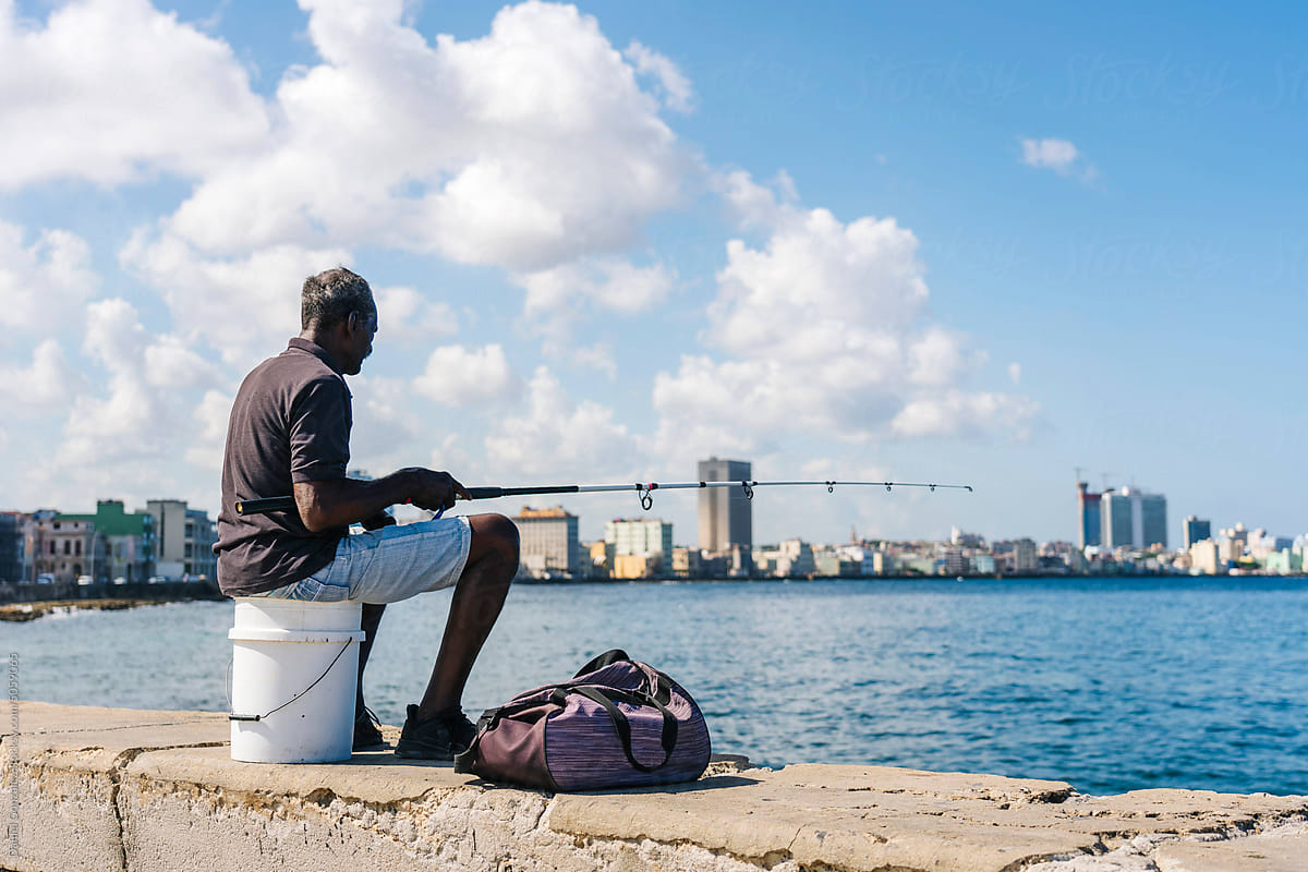 Senior man catching fish on Malecon de la Habana