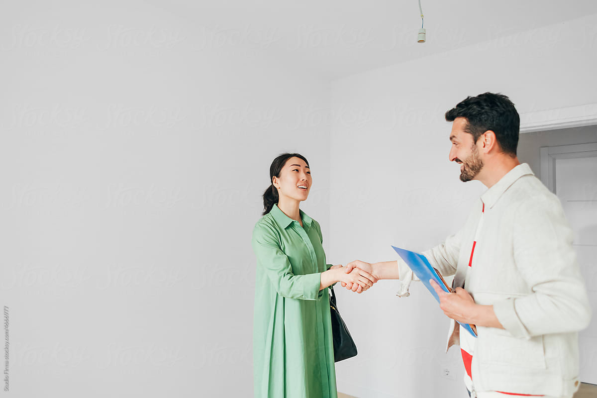 Real Estate Agent Shaking Hands with Client