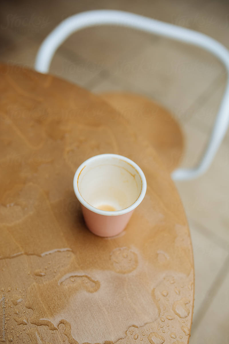 Empty cup on a wet table