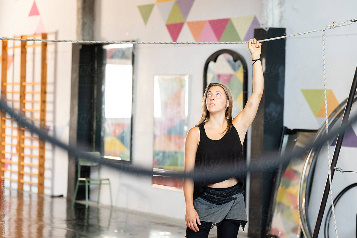 Woman preparing tightrope before training in gym