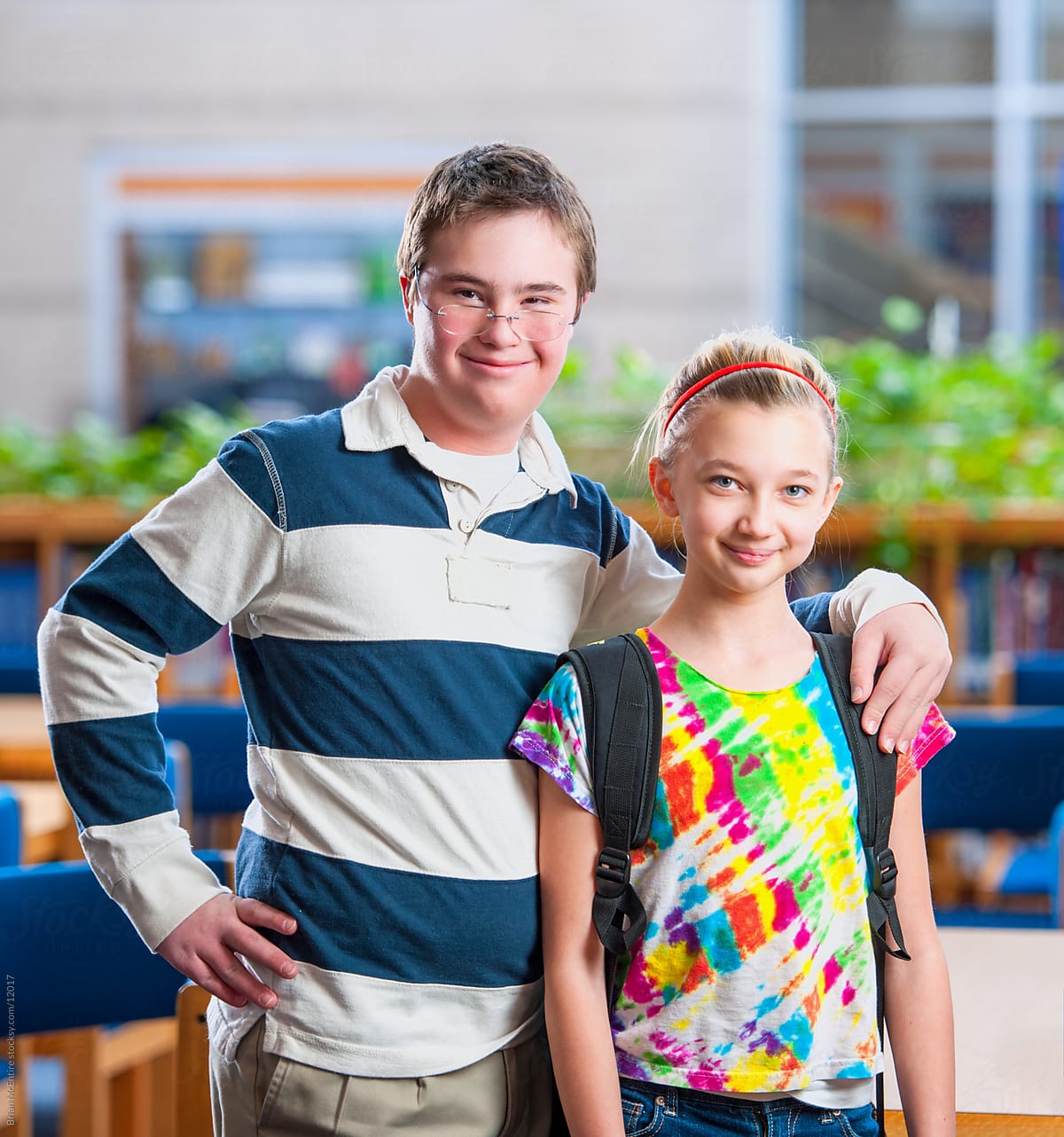 Middle School Girl and High School Boy with Down Syndrome Together in Library