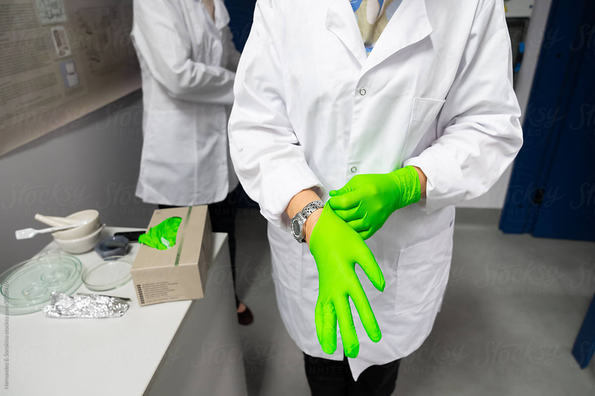 Scientists Putting On Gloves