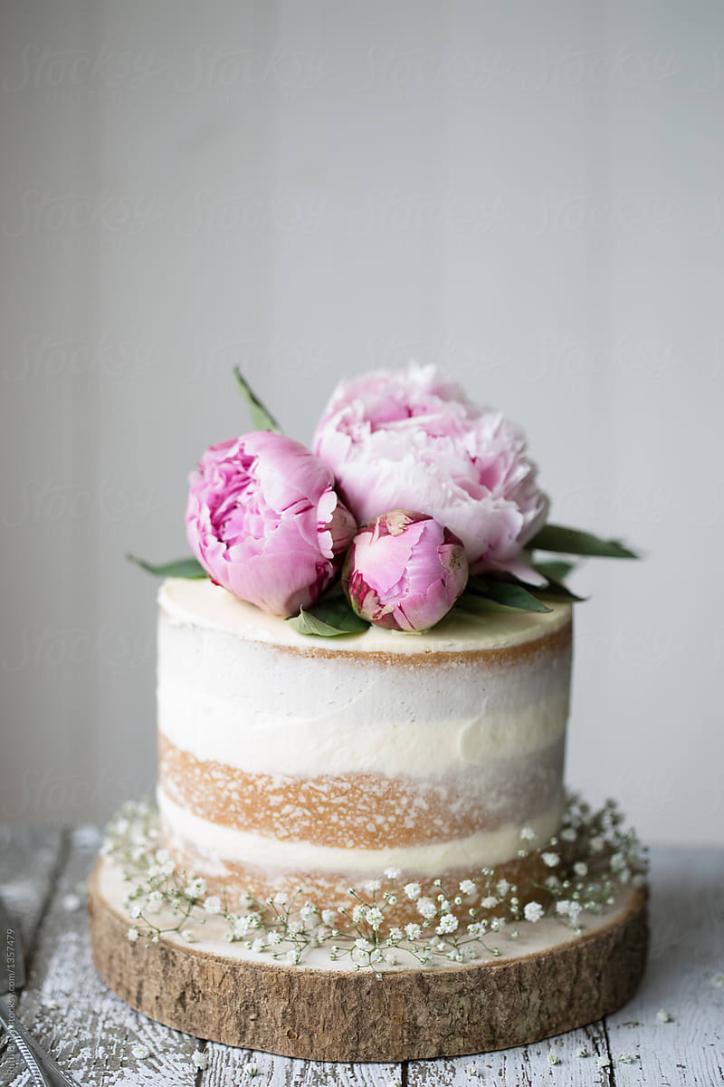 Naked Wedding Cake Decorated With Fresh Flowers By Stocksy Contributor Ruth Black Stocksy 