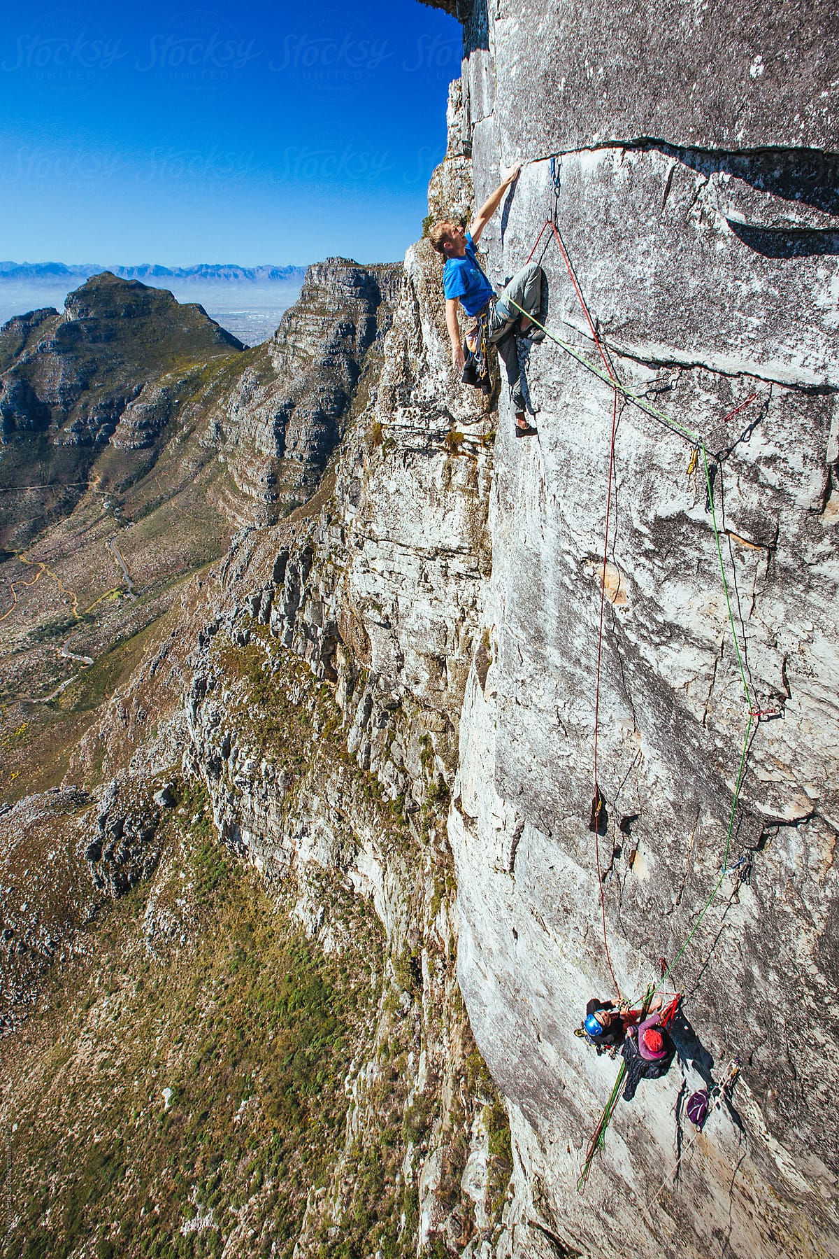 Rock climbers on a sheer cliff face