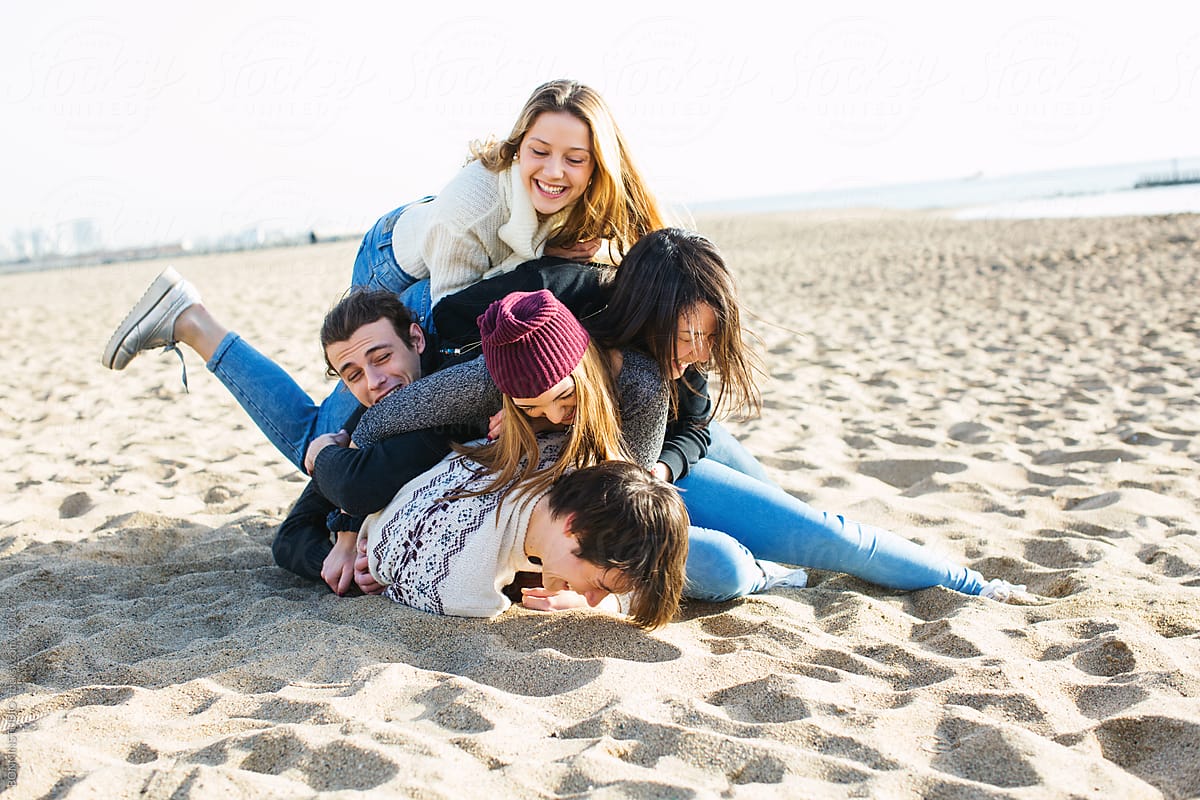 group of friends having fun on beach
