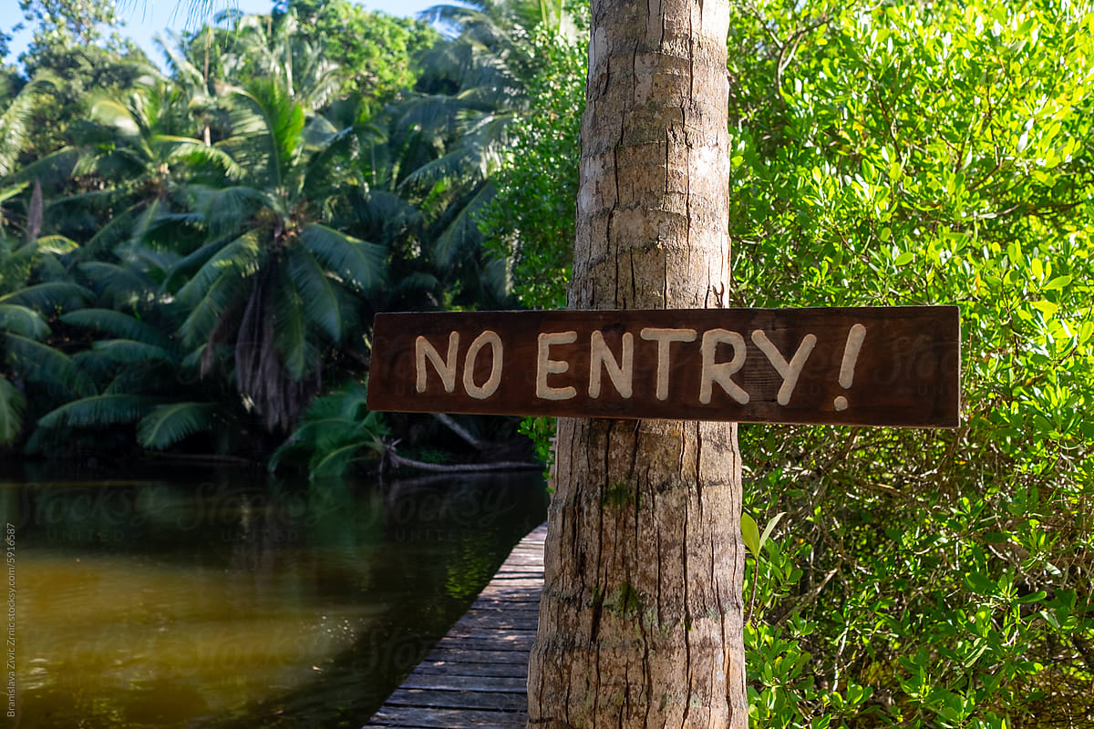 No entry sign on a tree next to a river on Seychelles Island