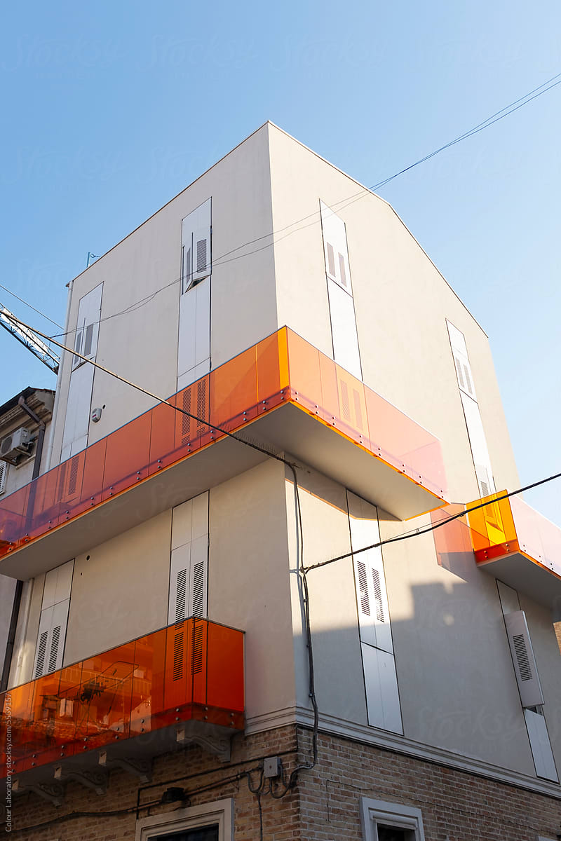 Building with transparent plastic neon orange balconies