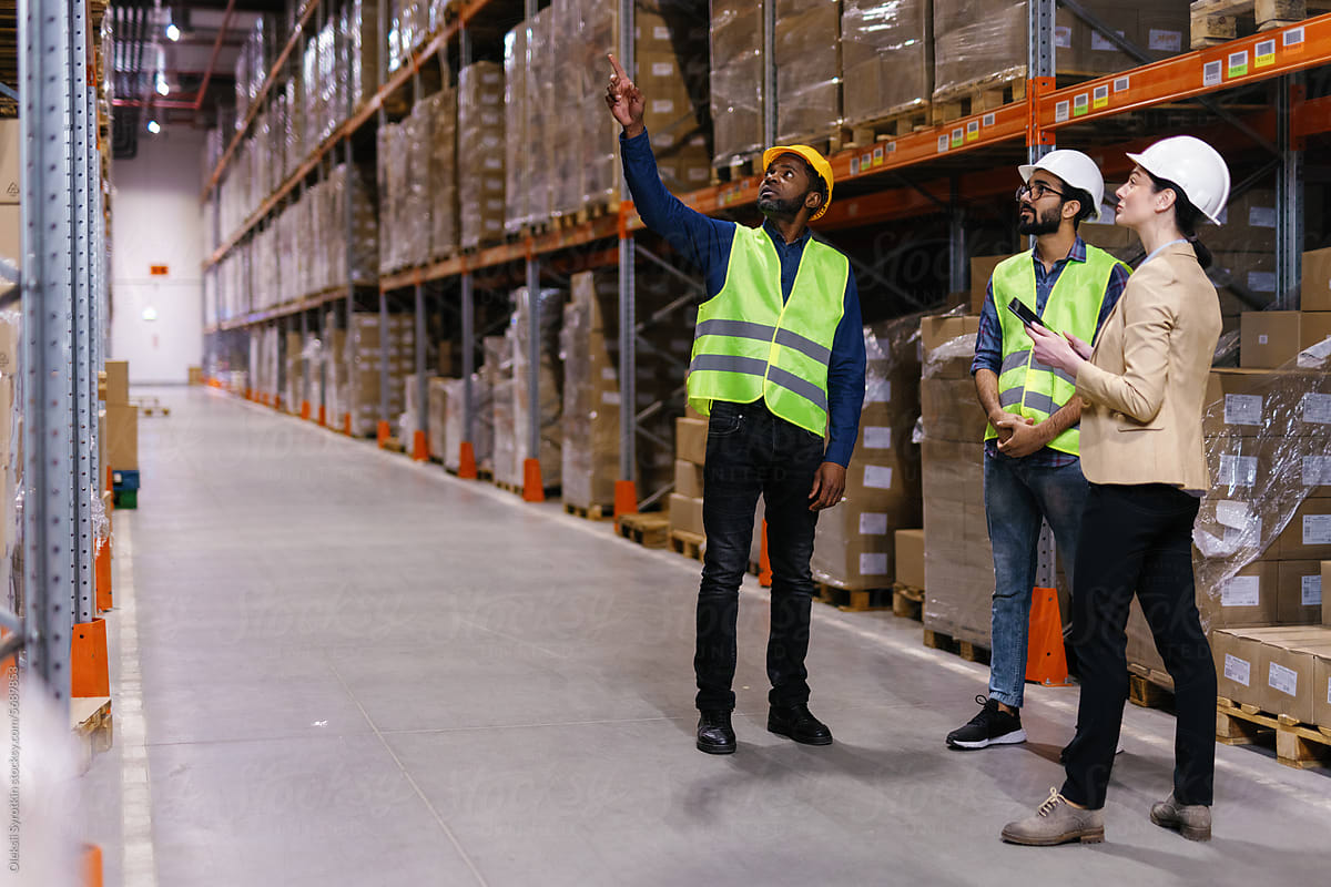 Boss logistic workers at warehouse