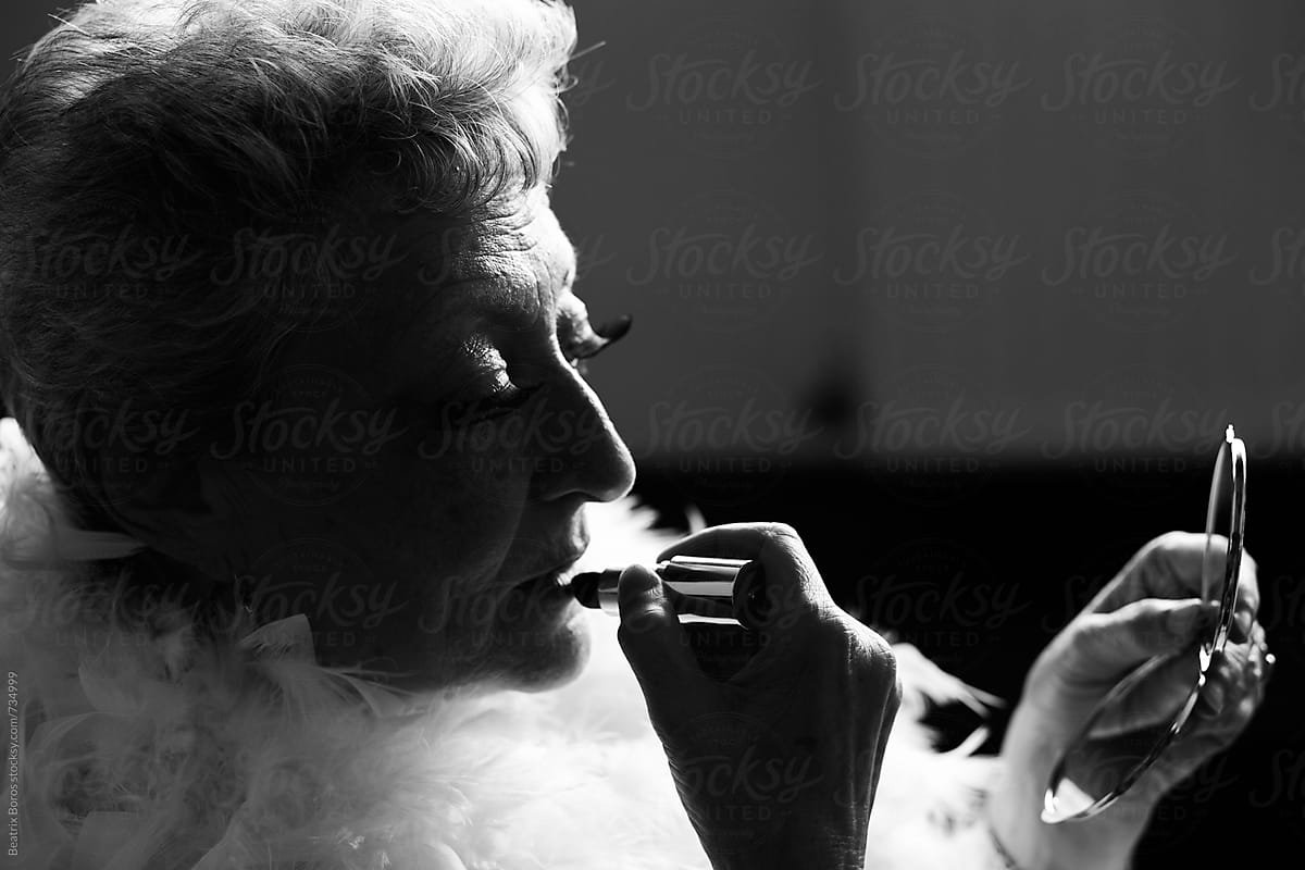 Senior Theatrical Woman Puts On Lipstick By Stocksy Contributor Beatrix Boros Stocksy 9081