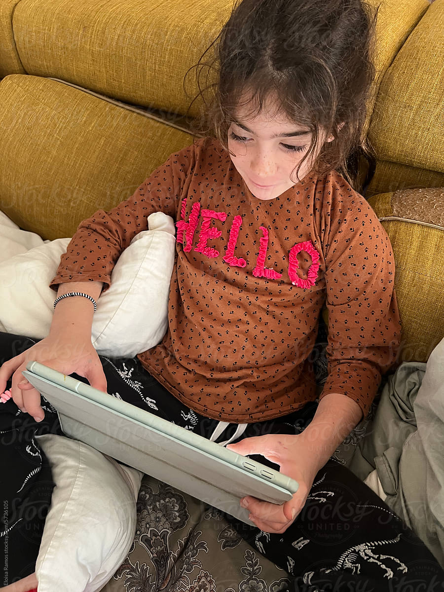kid Engrossed in Digital World with tablet UGC