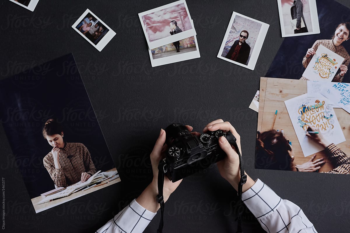 Photographer with printed pictures