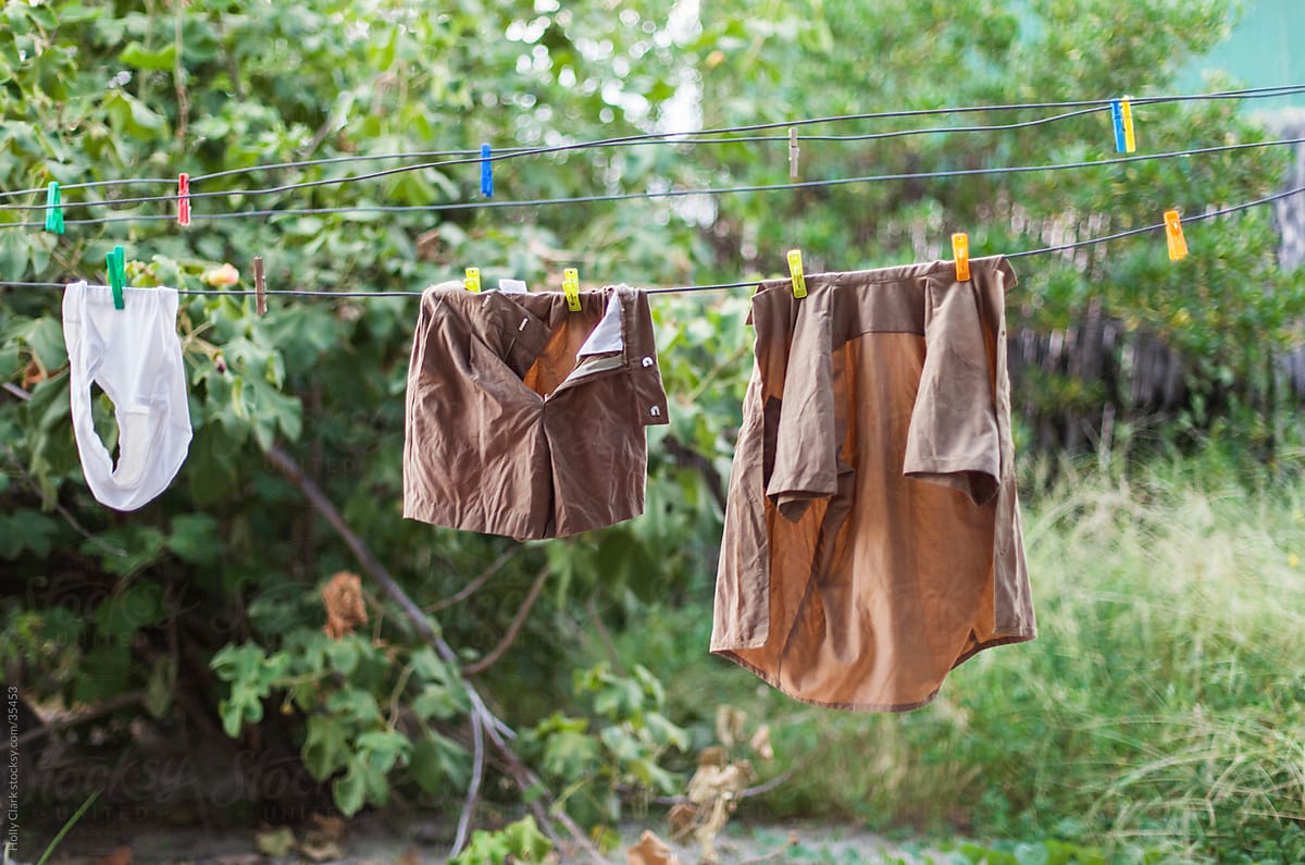 Child\'s brown uniform and underwear on laundry line.