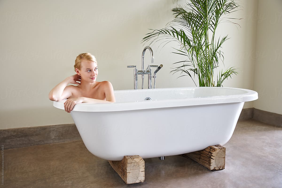 Woman relaxing in bathtub at luxury resort and spa