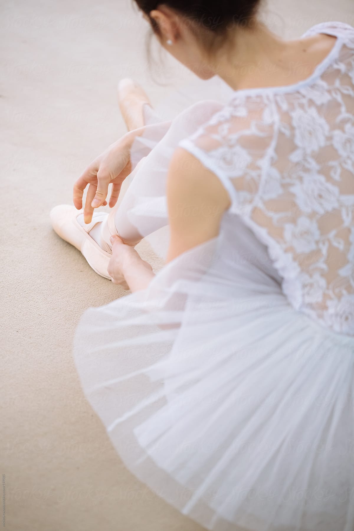 Classical dancer puts on pointe shoes