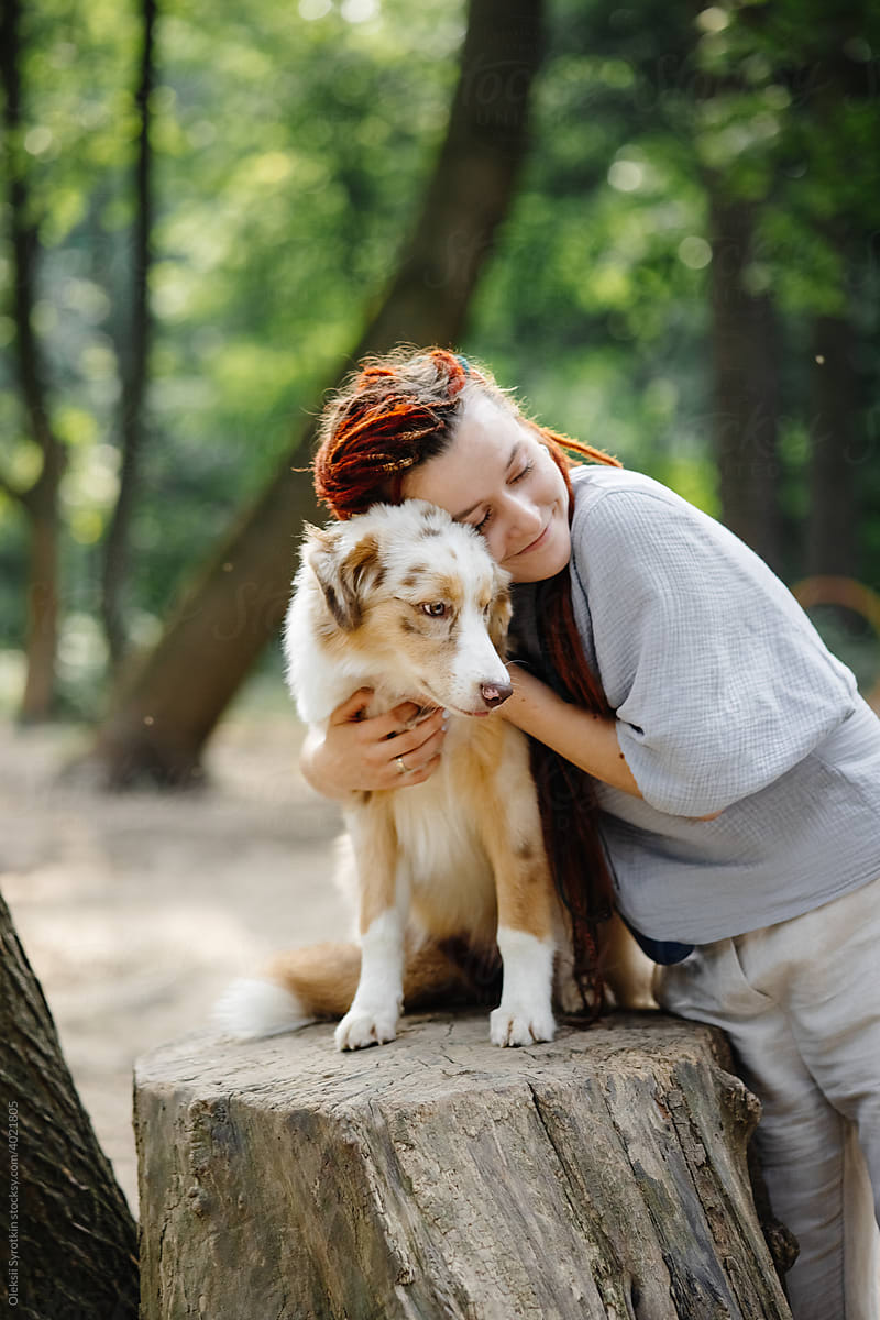 Female owner embracing animal