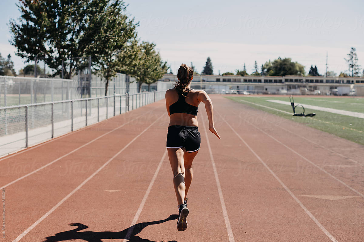 Back of Woman Running on Track