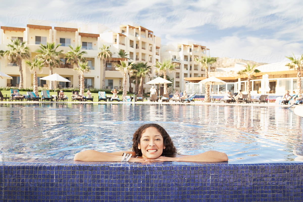 Portrait of happy woman relaxing on resort vacation