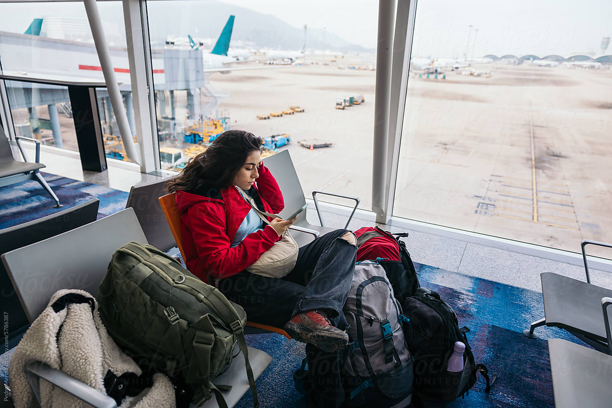 UGC Traveler Woman Using smartphone while Waiting At Airport