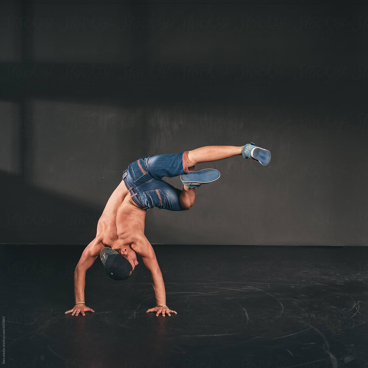 Break dancer posing with his feet up in the air