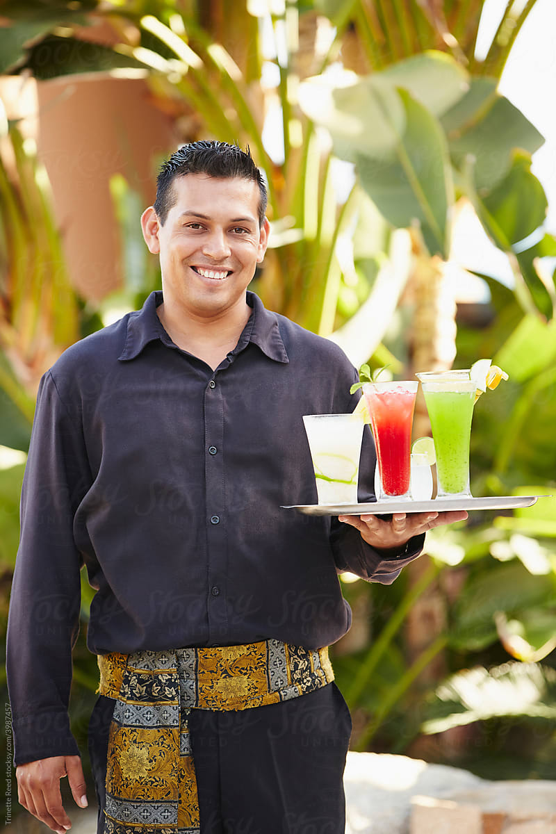 Portrait of staff service person with cocktail drinks