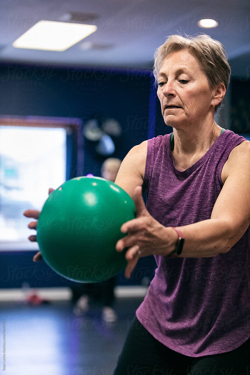 Senior Woman Using Exercise Ball During Workout