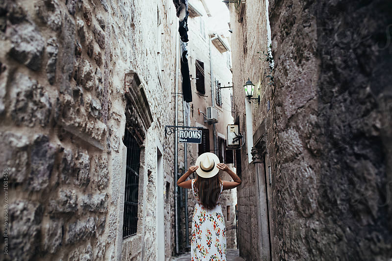 Young woman exploring an old town Kotor