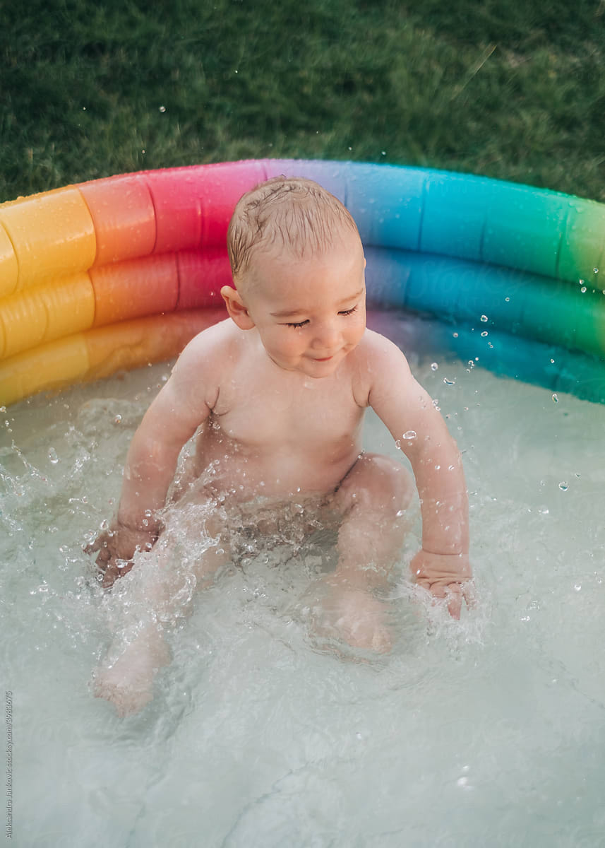 Baby In The Colorful Kiddie Pool