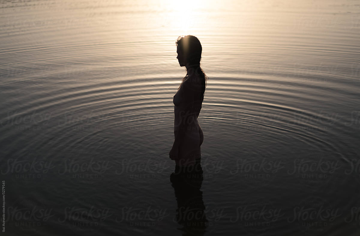 Dreamy portrait of standing woman in the water