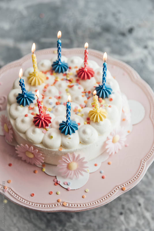 Food: Candles on birthday cake is being lighted
