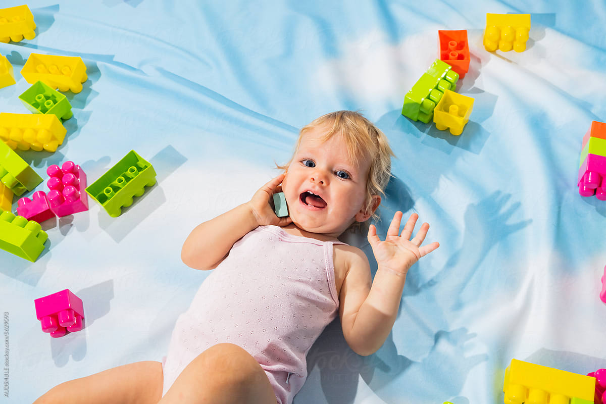 Happy baby surrounded with blocks