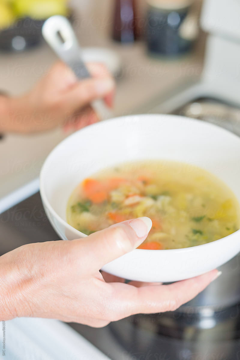 Serving Chicken Soup into a Bowl