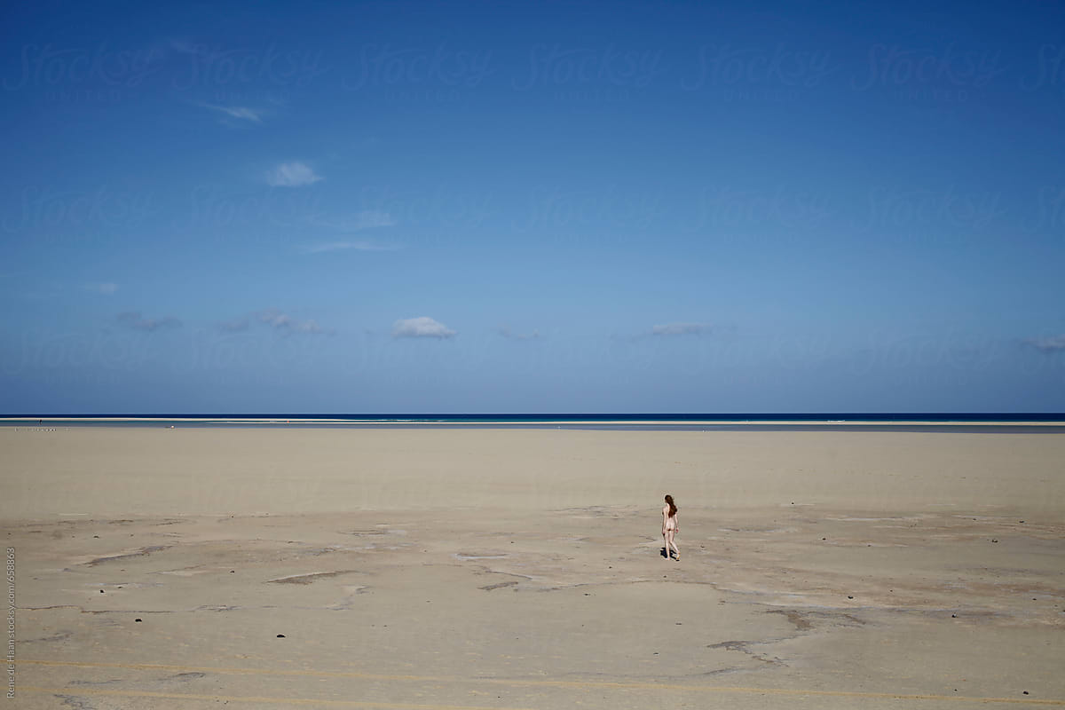 Nude Woman Walking On Huge Empty Beach By Stocksy Contributor Rene De Haan Stocksy