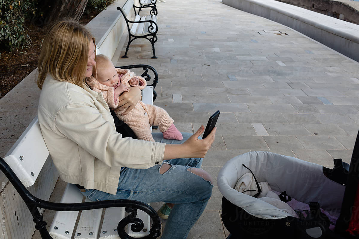Woman taking a selfie with her baby outdoors