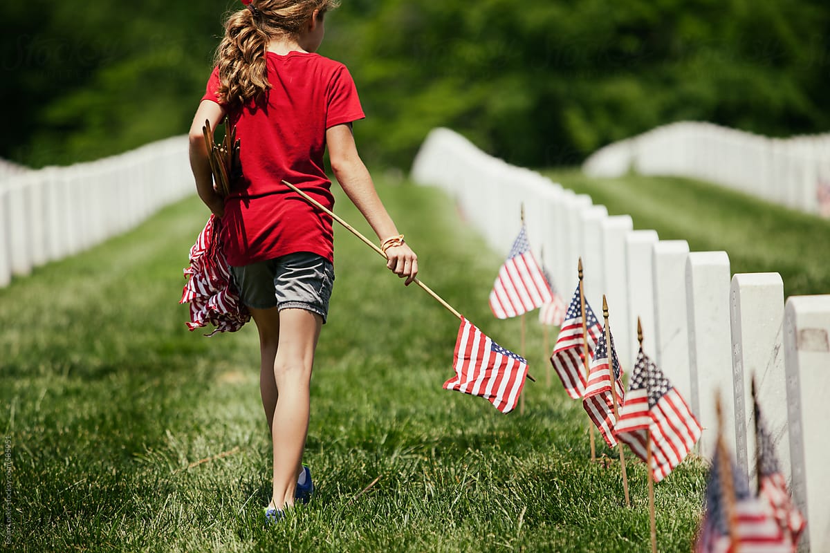 Memorial: Girl Walks Through Cemetary Placing American Flags