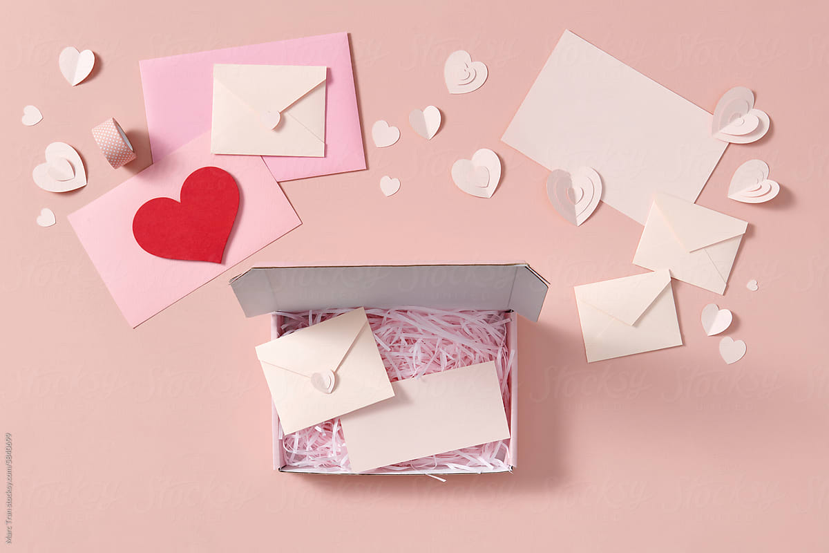Valentine's Day flat lay with love letter envelope, red pink hearts