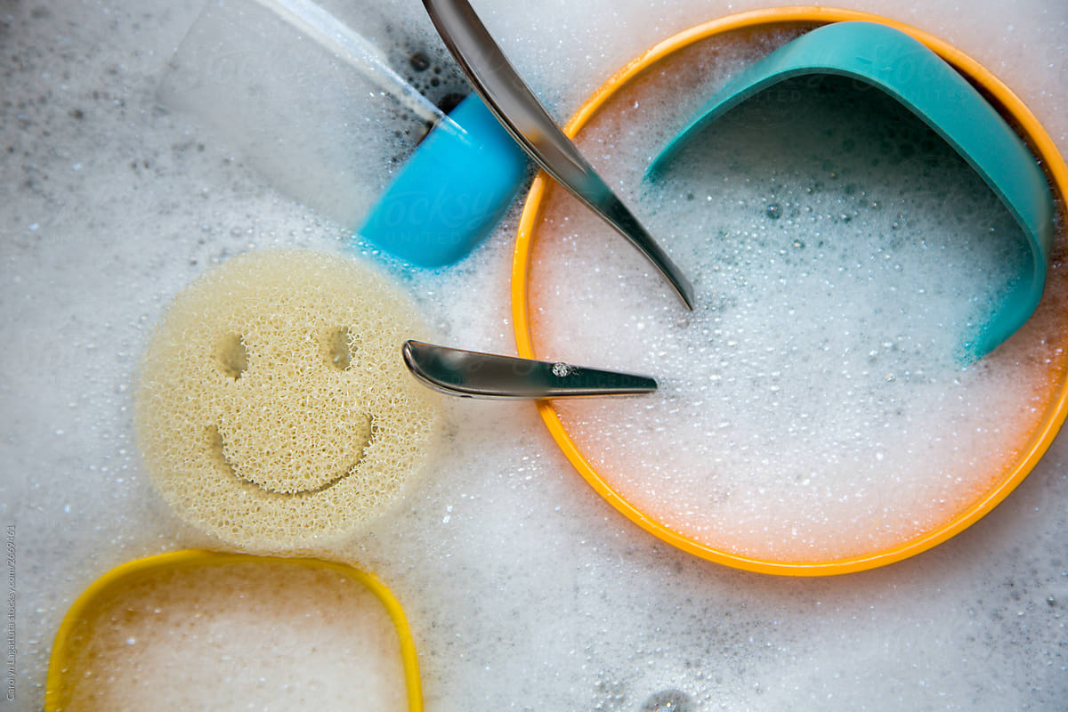 Dirty dishes and a smiley sponge