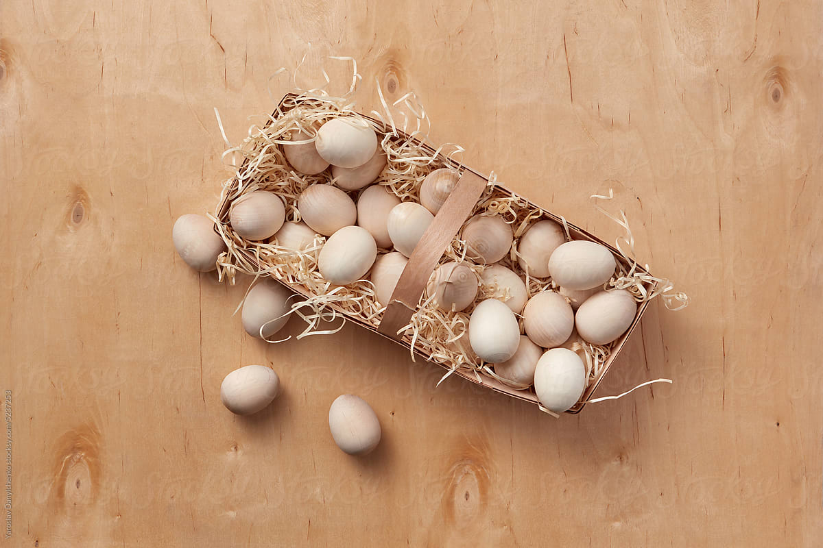 Natural colored wooden Easter eggs in eco basket.