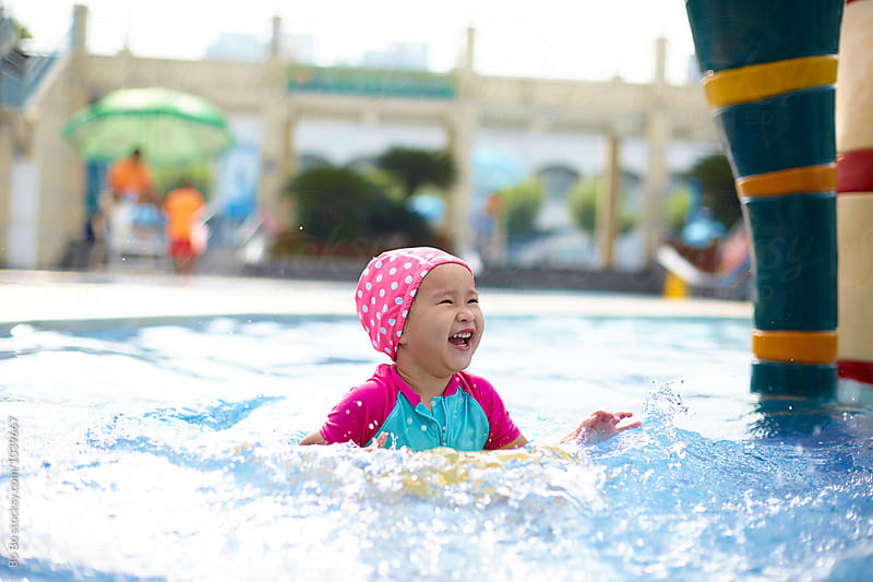 happy little asian girl in the swimming pool