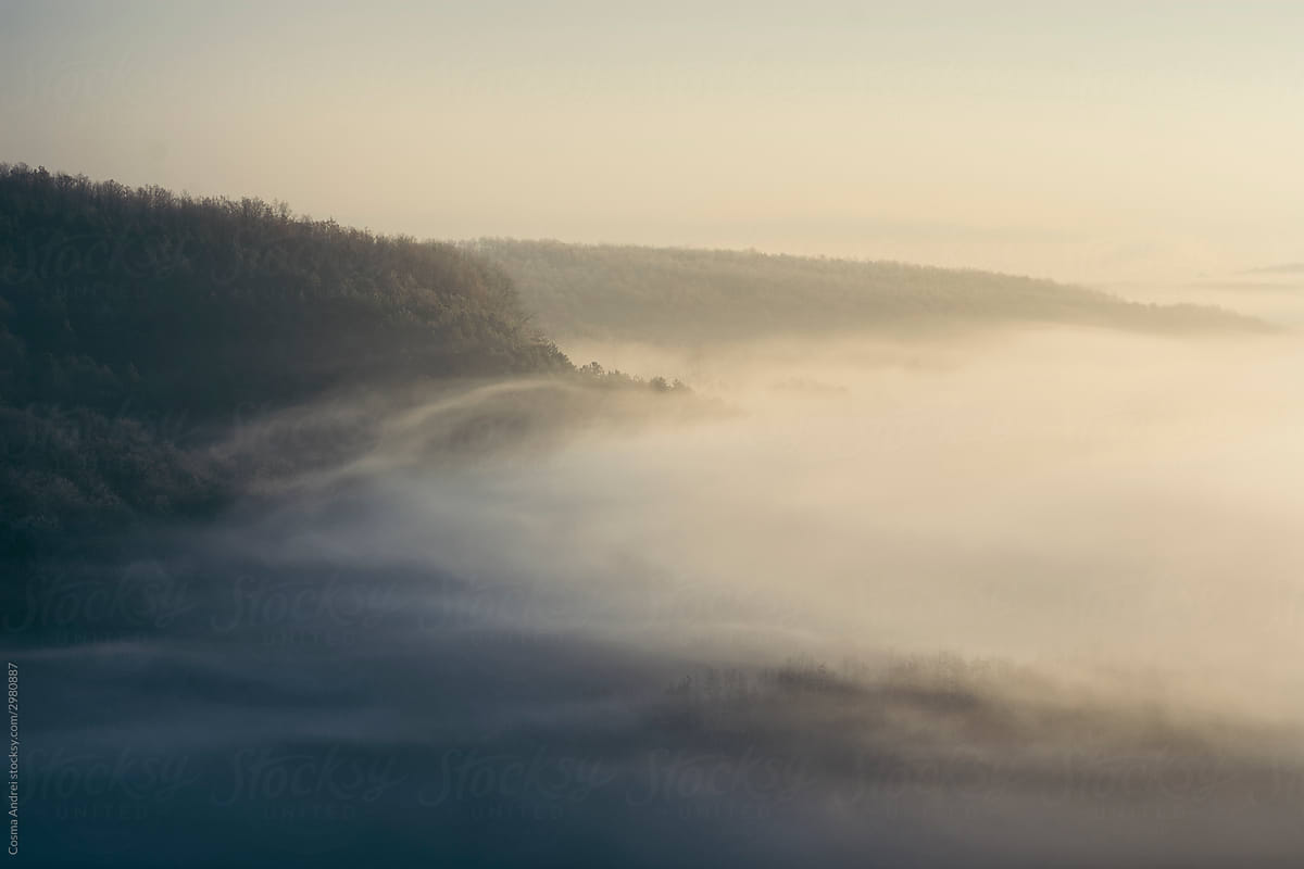 Ethereal morning landscape with fog and sun light