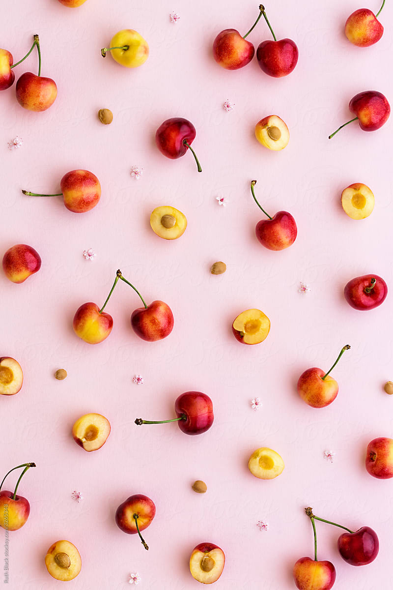 Red And Yellow Cherries On A Pink Background