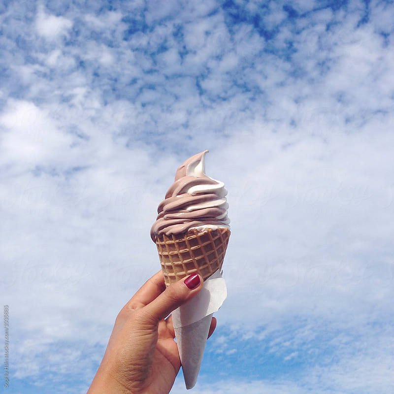 Hand holding Ice cream and blue sky
