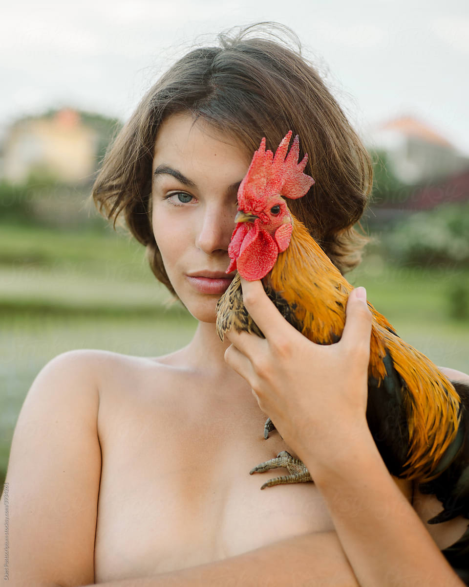 Beautiful young woman with cock in her arms