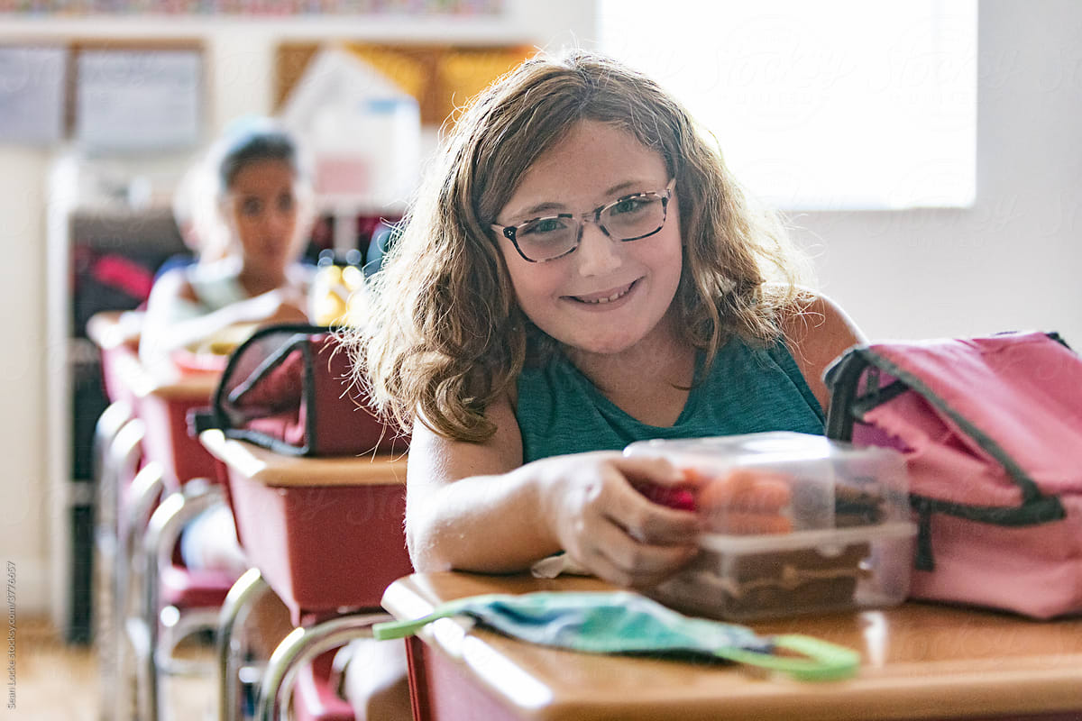 School: Student Smiles At Camera Before Eating Lunch