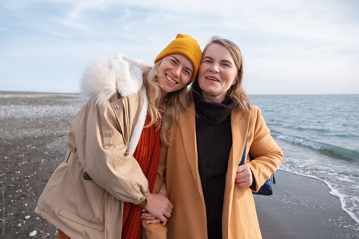 Happy mother and daughter near stormy sea