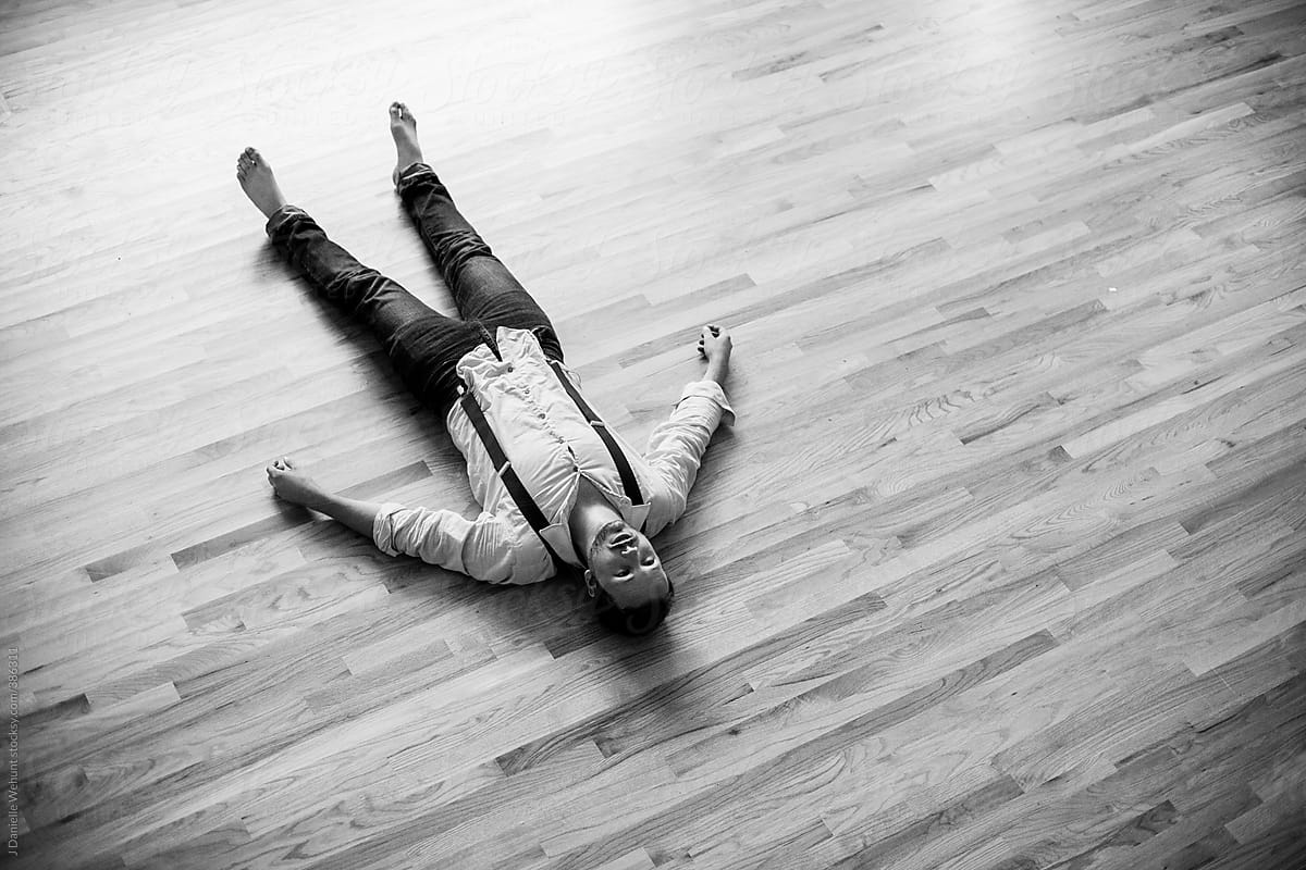 Man Lying On The Hardwood Floor By J Danielle Wehunt Stocksy United