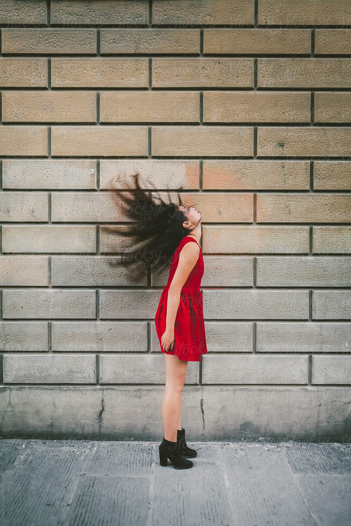 Asian Woman in Red Dress Flipping Her Hair