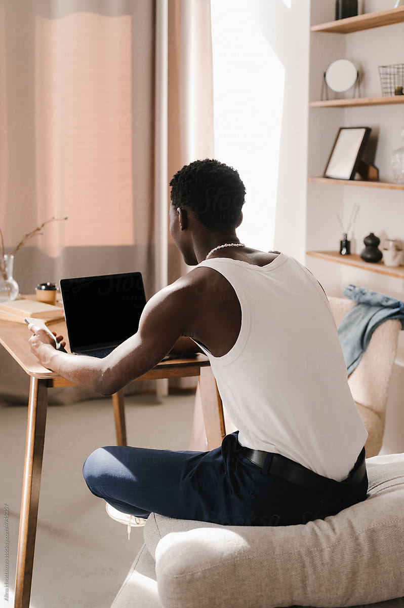 Woman Sitting At Desk With Laptop by Stocksy Contributor Alina